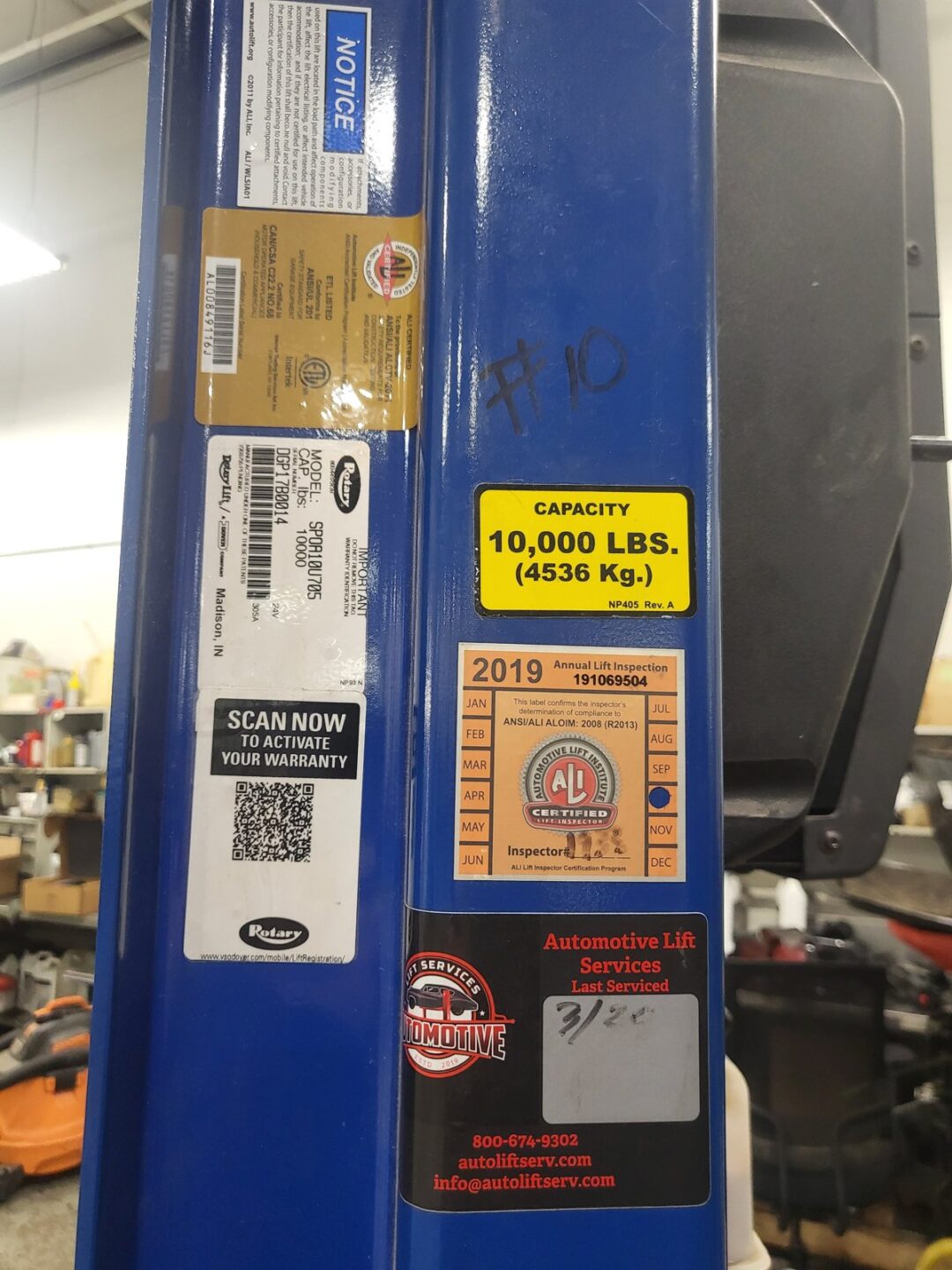 Rotary SPOA10U705 10000 lb lift with ALI certification sticker and Automotive Lift Services inspection tag