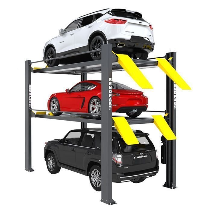 BendPak triple-level 4-post parking lift storing three vehicles on white background