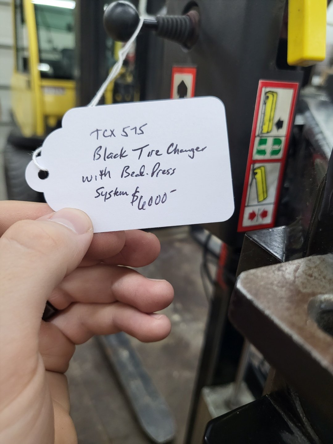 TCX 575 black tire changer with bead press system price tag $6000 in shop