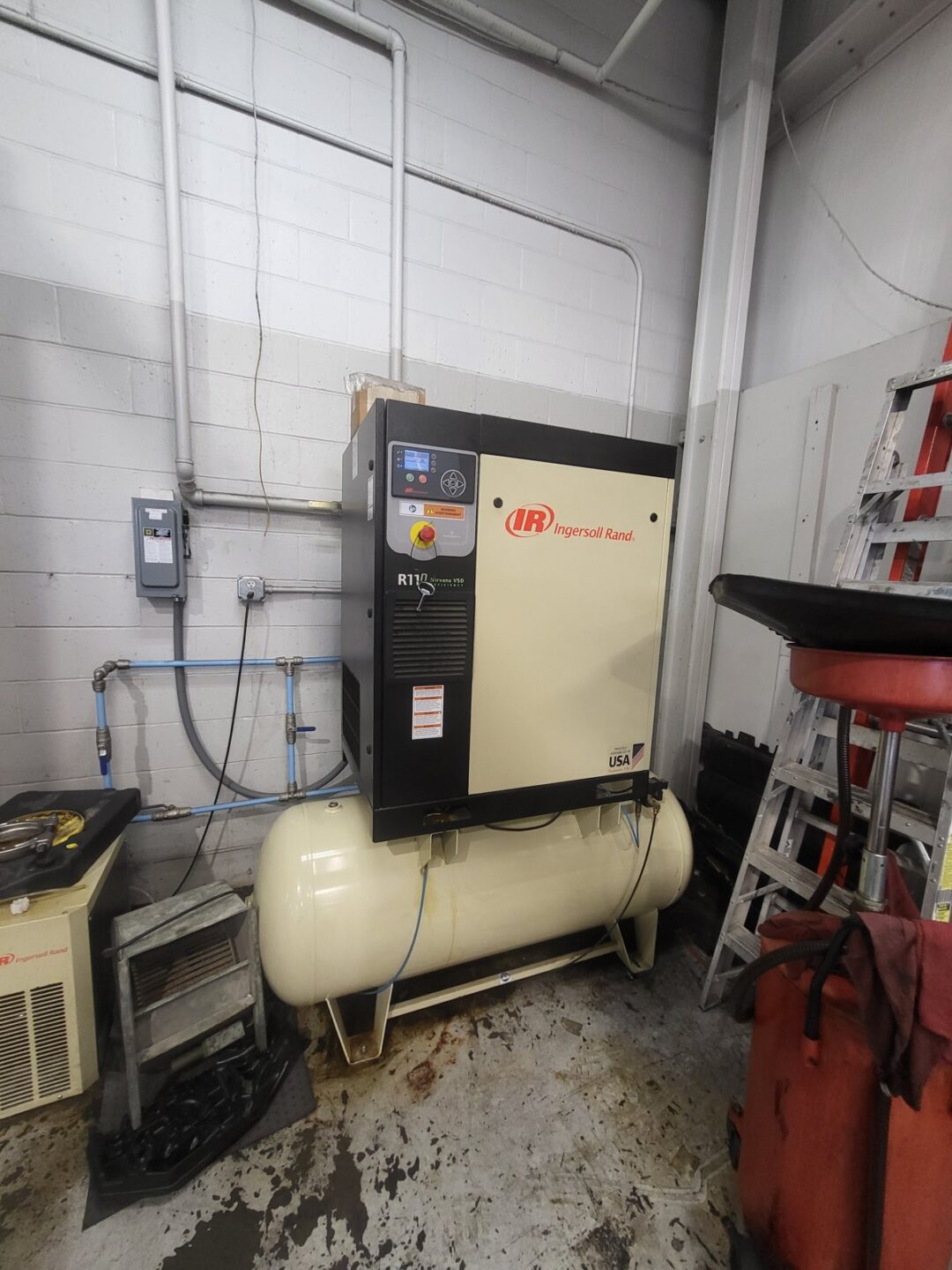 Ingersoll Rand R110 rotary screw air compressor with horizontal tank in automotive shop