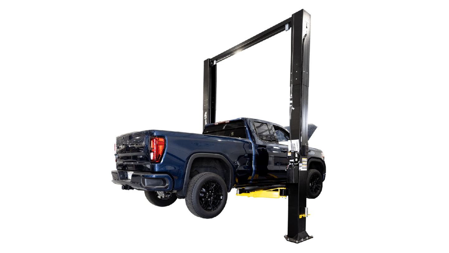 2-post automotive lift raising a blue GMC Sierra heavy-duty truck on a white studio background