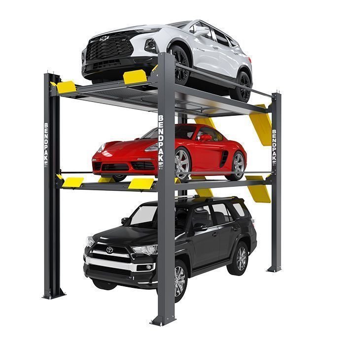 BendPak triple-level 4-post parking lift storing three vehicles on white background