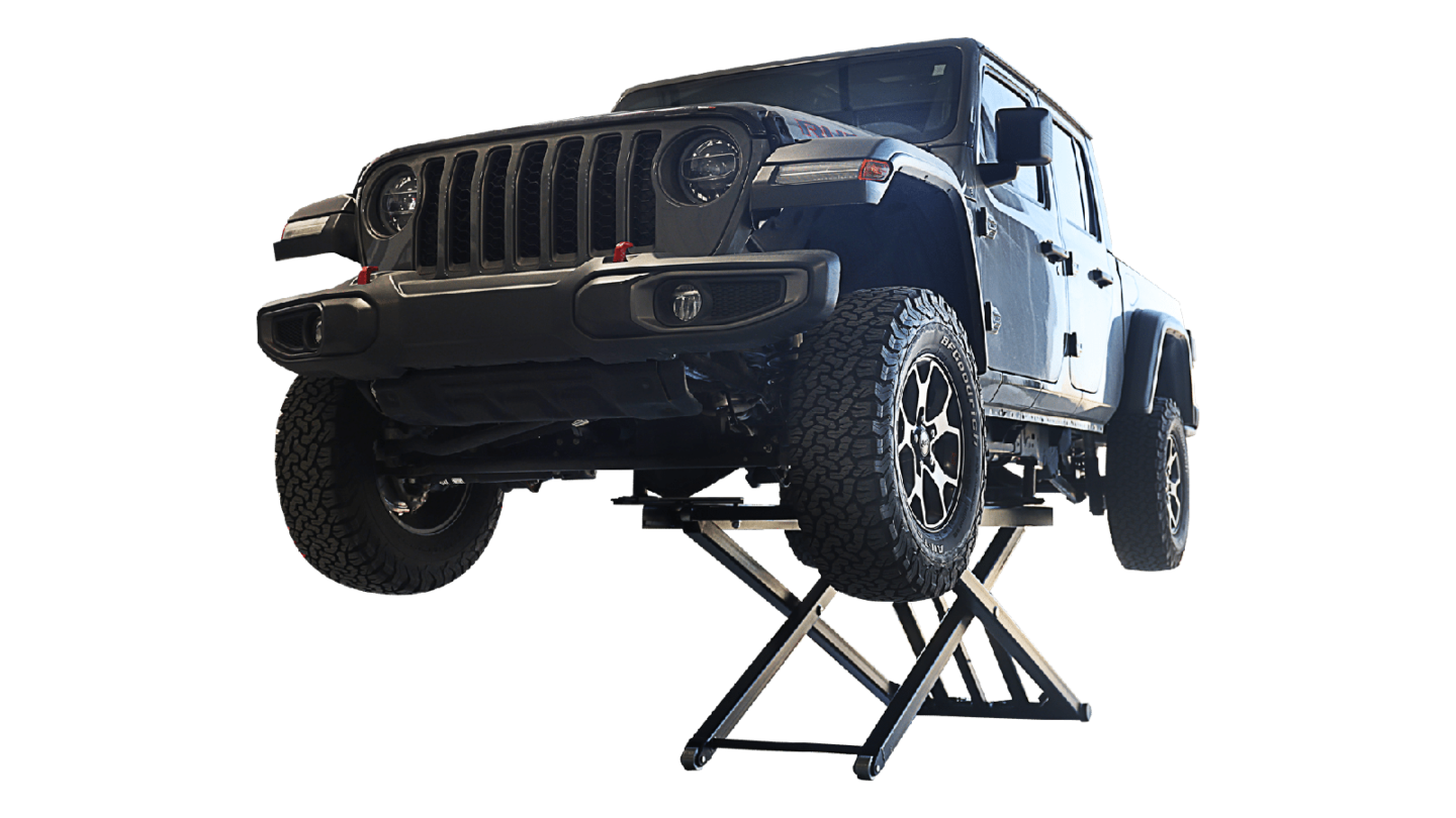 Jeep Gladiator raised on portable scissor jack lift with green background cutout