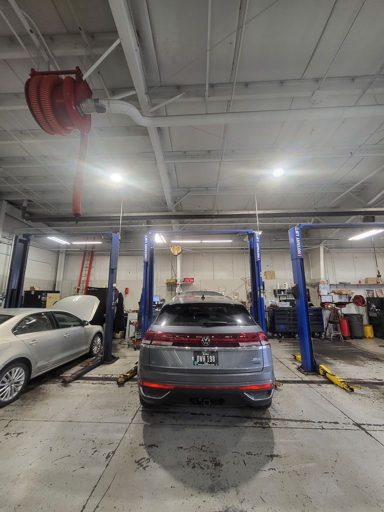 Rotary 2-post lifts installed in Iowa auto repair shop with VW and sedan on service bays