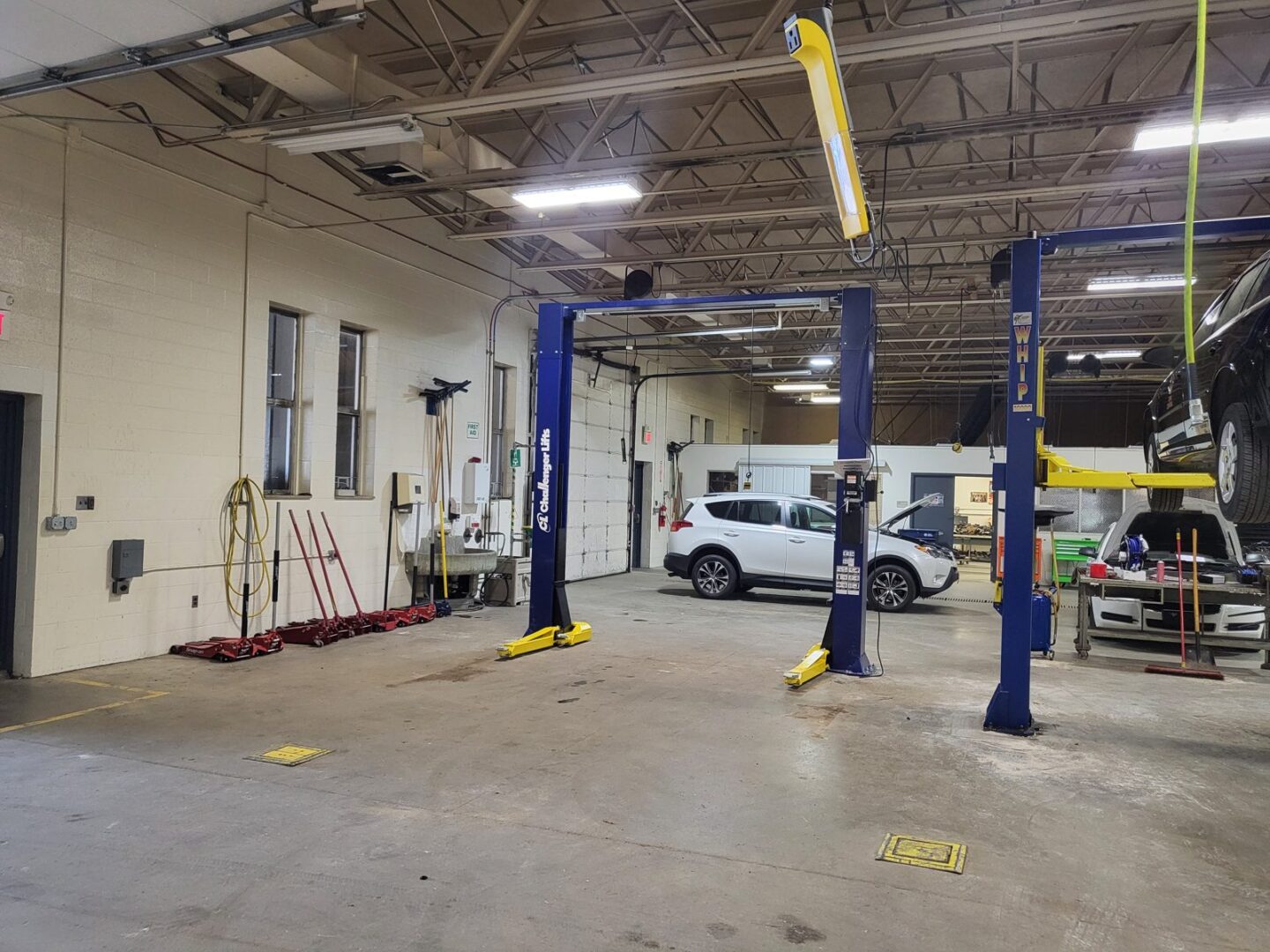 Freshly installed Challenger two-post lift by Auto Lift Services