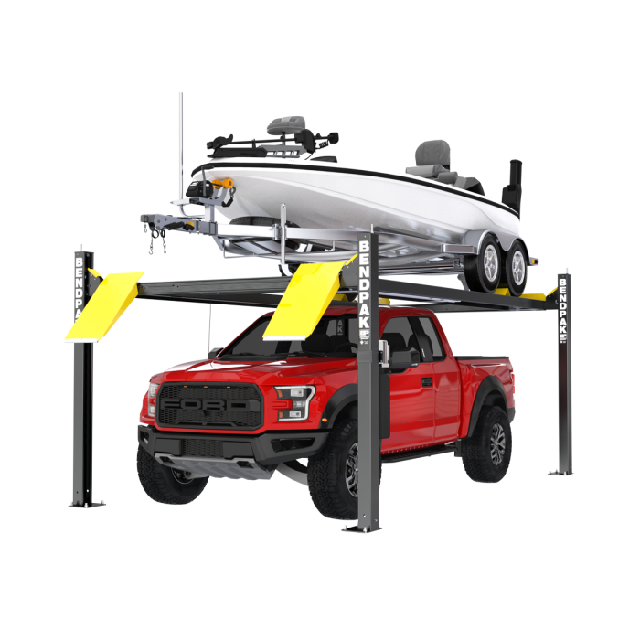 BendPak 4-post storage lift holding a boat on trailer above a red Ford F-150 Raptor