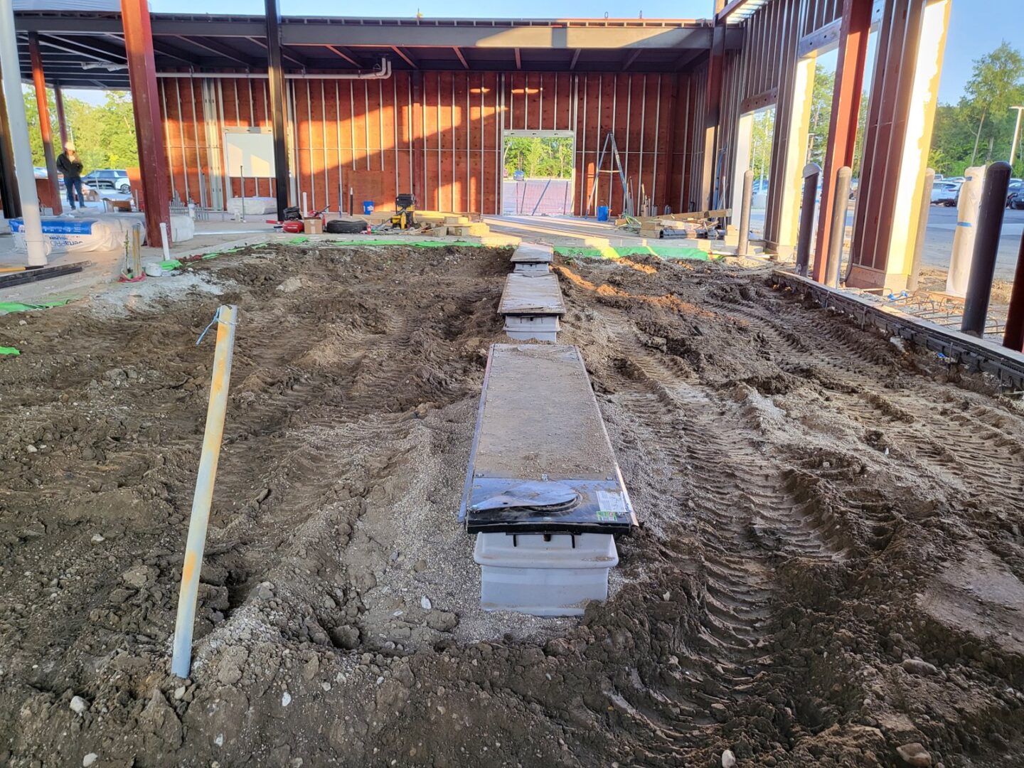 Inground lift pit excavation and cylinder housing installation inside new automotive service bay