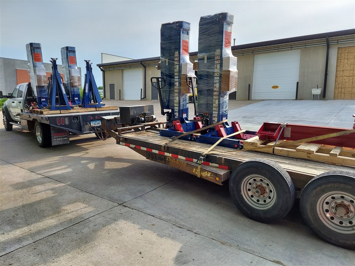 Wireless mobile column lifts loaded for delivery on an Automotive Lift Services truck and trailer in Iowa